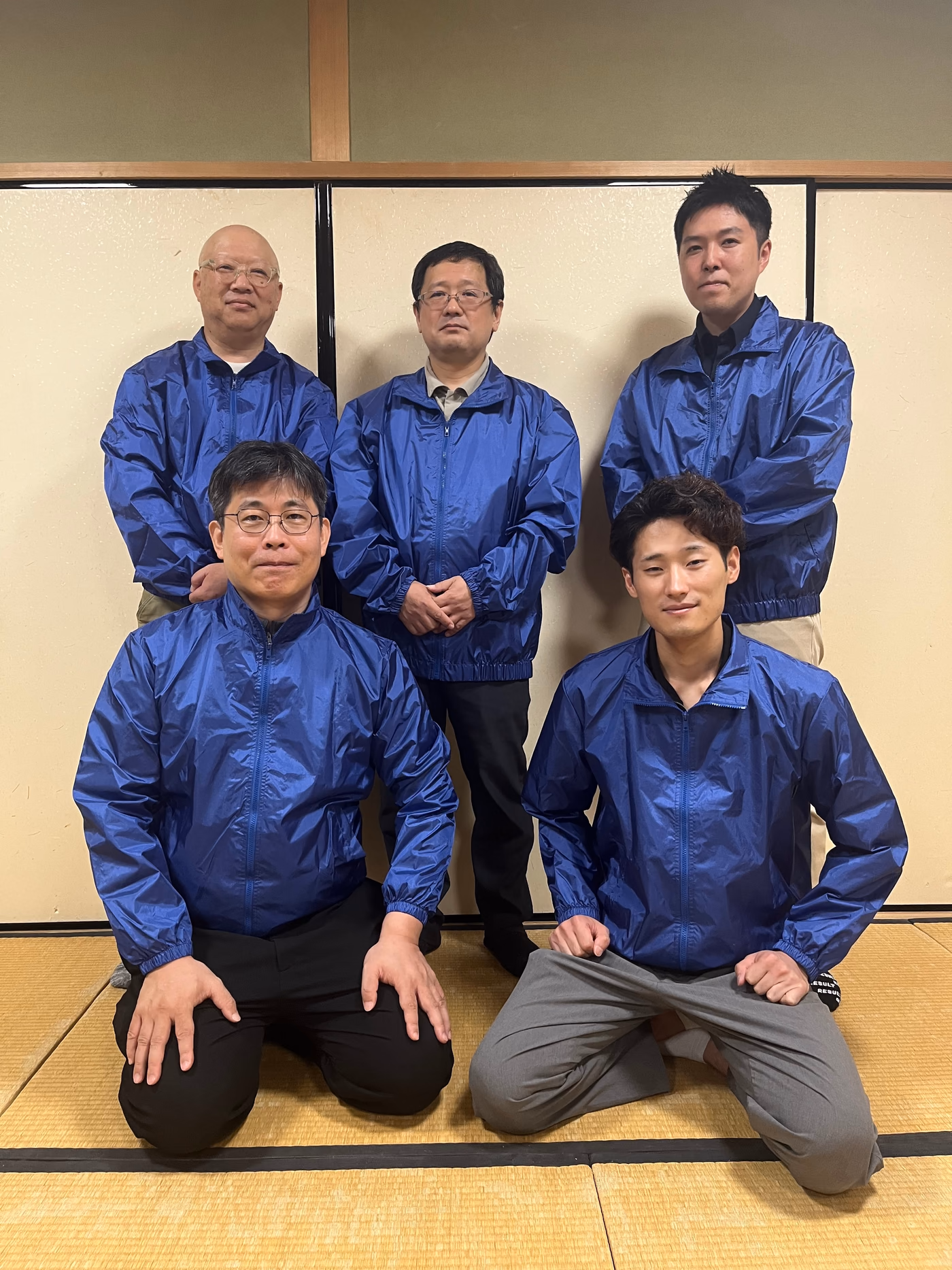 青いユニフォームを着た北九州物販事業者協同組合の組合メンバー5名